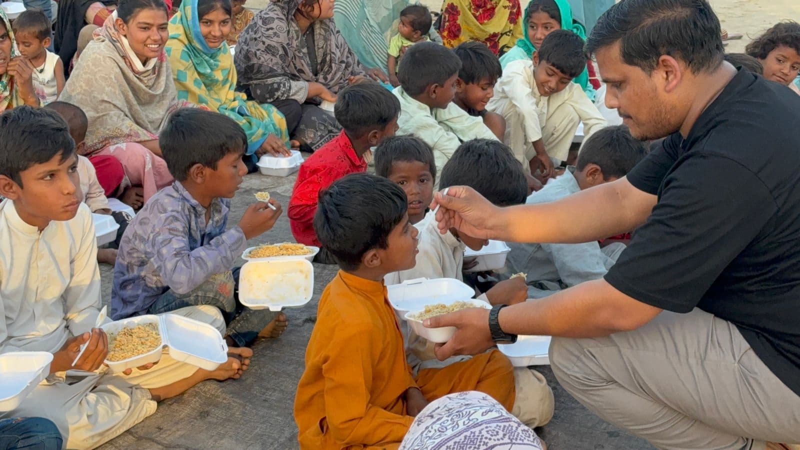 Children receiving food during a Sunday school and outreach gathering